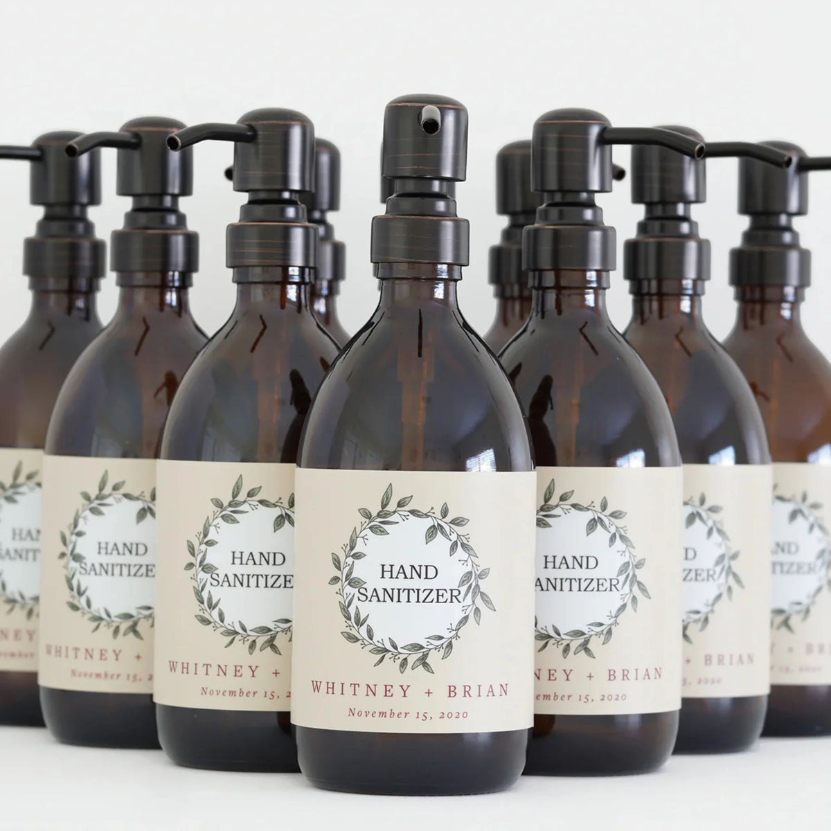 Custom apothecary bottles of hand sanitizer, each featuring unique labels for a personalized touch in hygiene