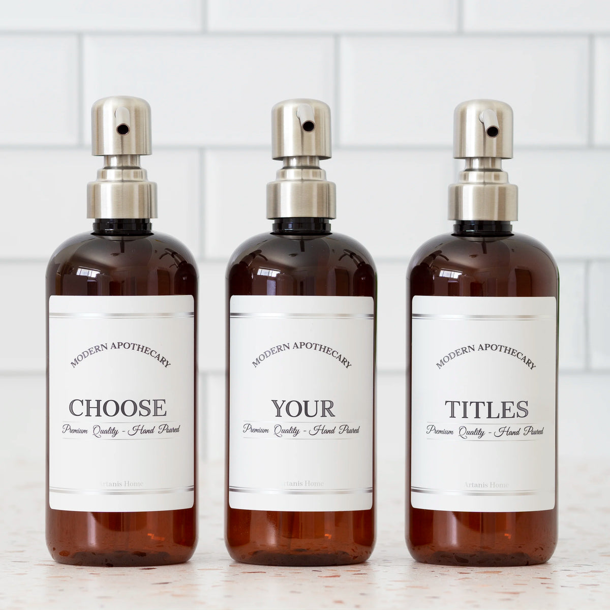 Amber PET set of refillable bottles with stainless steel pumps and choice of coordinated labels.