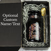 Customized black gift tea jar made of Miron glass in the apothecary style, nestled in a black gift box with an alloy spoon.