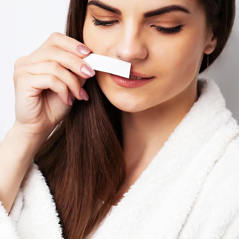 Woman trying a fragrance sample of Lavicity custom scented hotel liquid amenities.