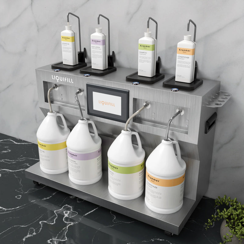 LIQUIFILL station filling various bottles from four gallon jugs on a gray marble surface.